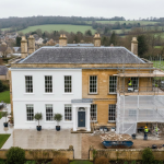Overhead image of a spacious house with scaffolding, suggesting repairs or upgrades are in progress